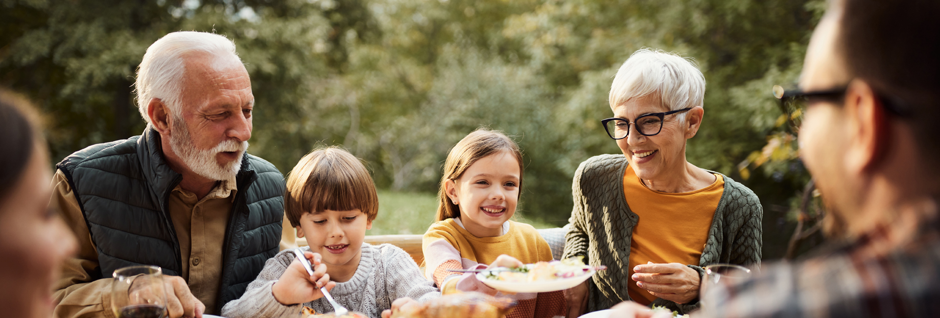 Großeltern in Pension essen mit Enkelkindern draußen